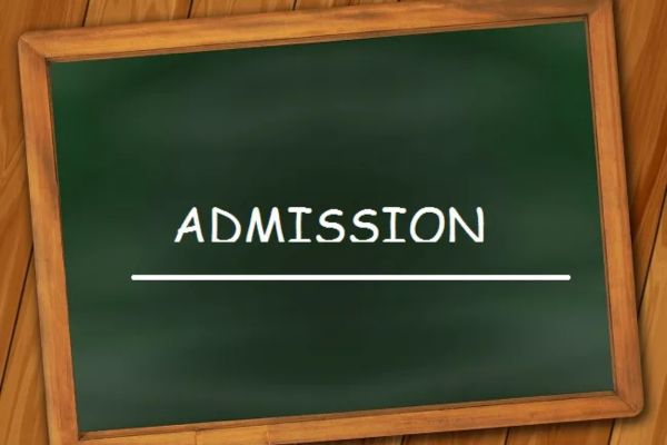 A wooden-framed chalkboard displays "ADMISSION" in white chalk, with a horizontal line below, against vertical wooden planks.