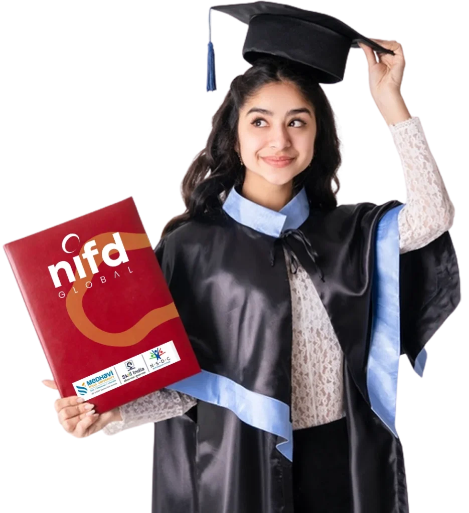 A young woman in a graduation cap and gown smiles, holding a maroon folder that says "nifd GLOBAL," adjusting her cap with one hand.